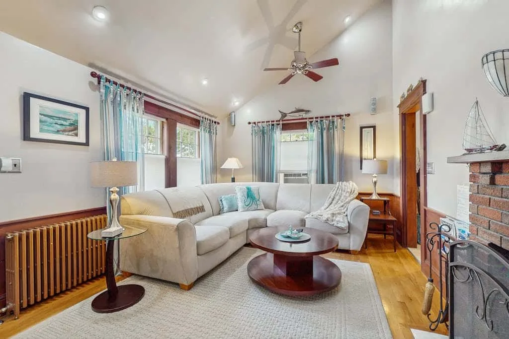 A bright living room with seating around a low coffee table.