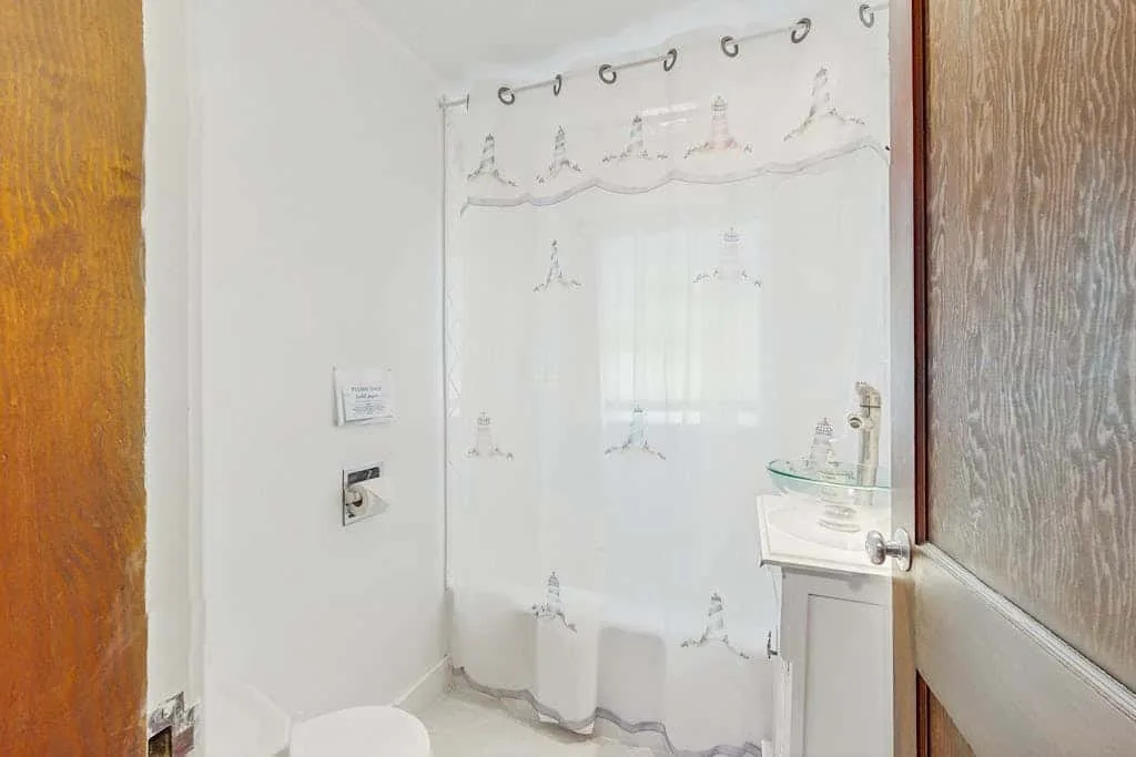 A bathroom with a glass shower and a sink.