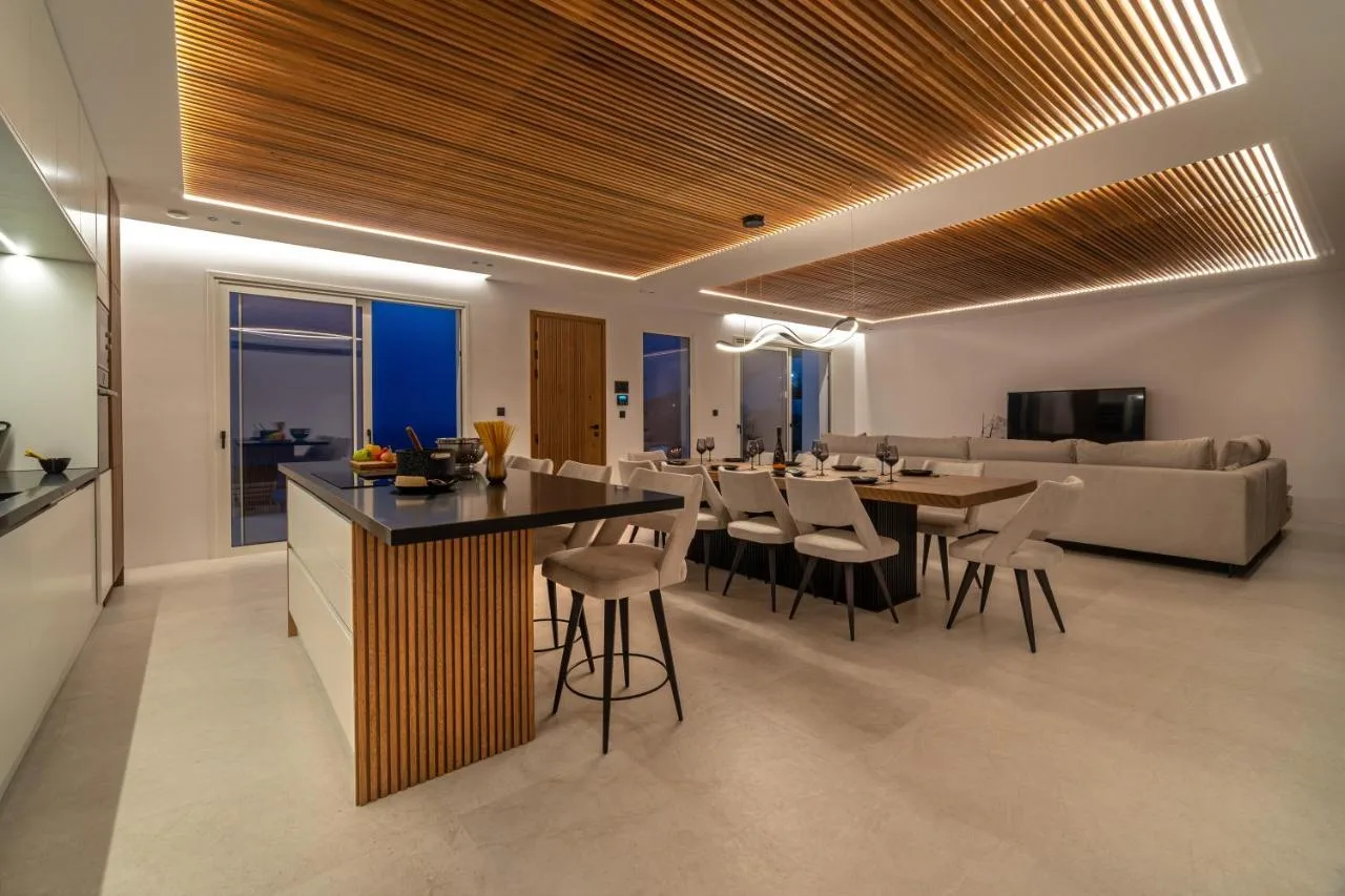 An open-plan living and dining area with a kitchen island and seating.