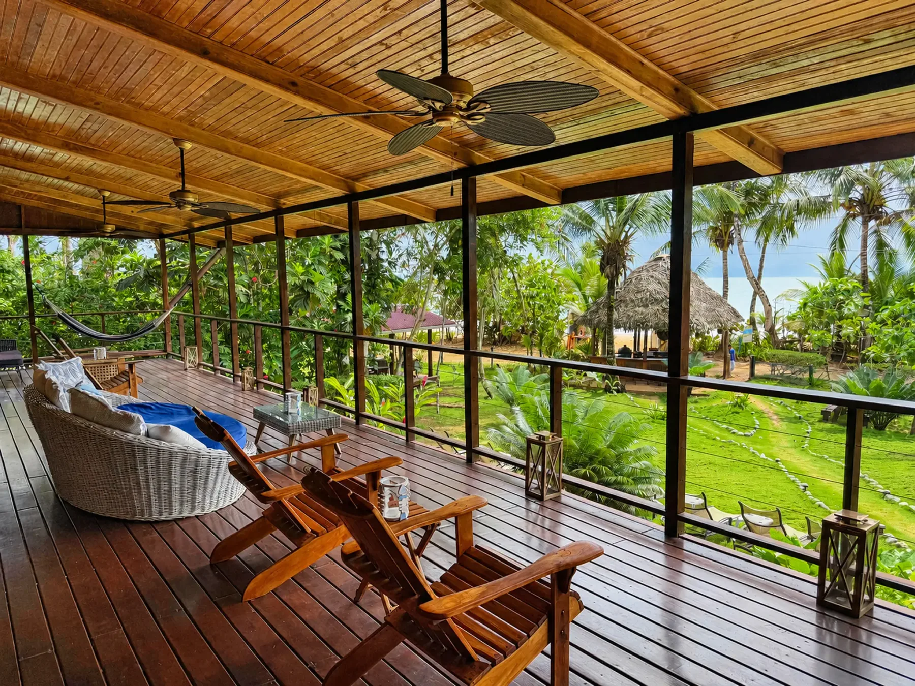 Upper Oasis terrace overlooking the gardens, tiki bar, and Bluff Beach