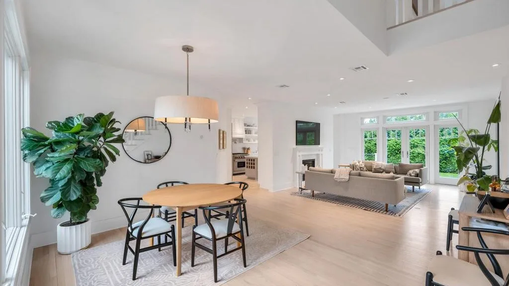 An open-plan living and dining area with a dining table and seating.