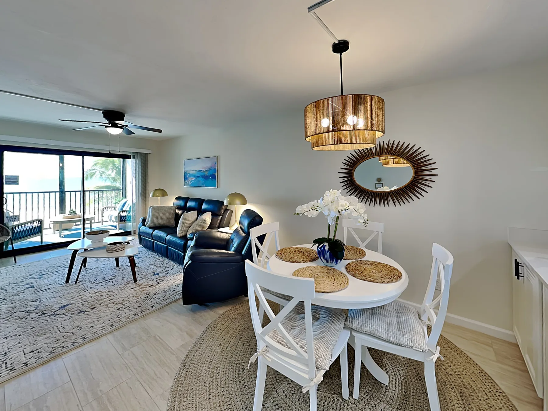 A bright living and dining area with a round table beside the seating area.