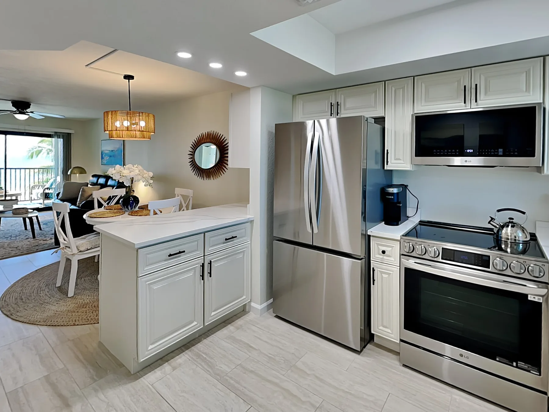 A bright kitchen with a central island and stainless steel appliances.