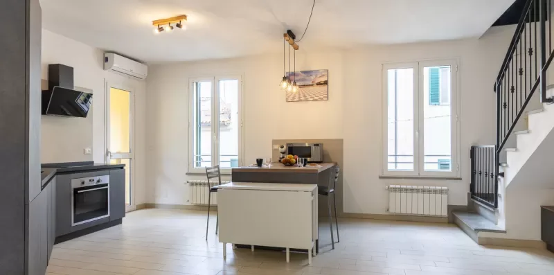 A bright kitchen and dining area with a counter and seating.
