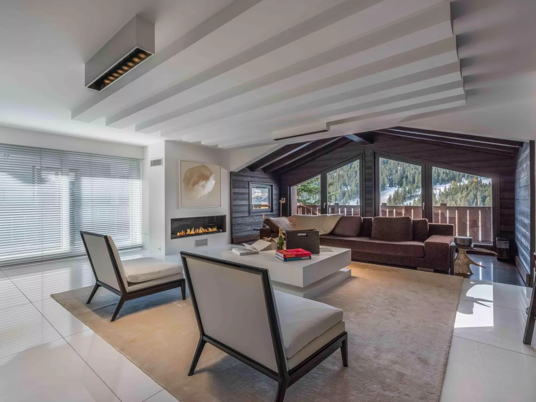 A bright living room with seating arranged around a low coffee table.