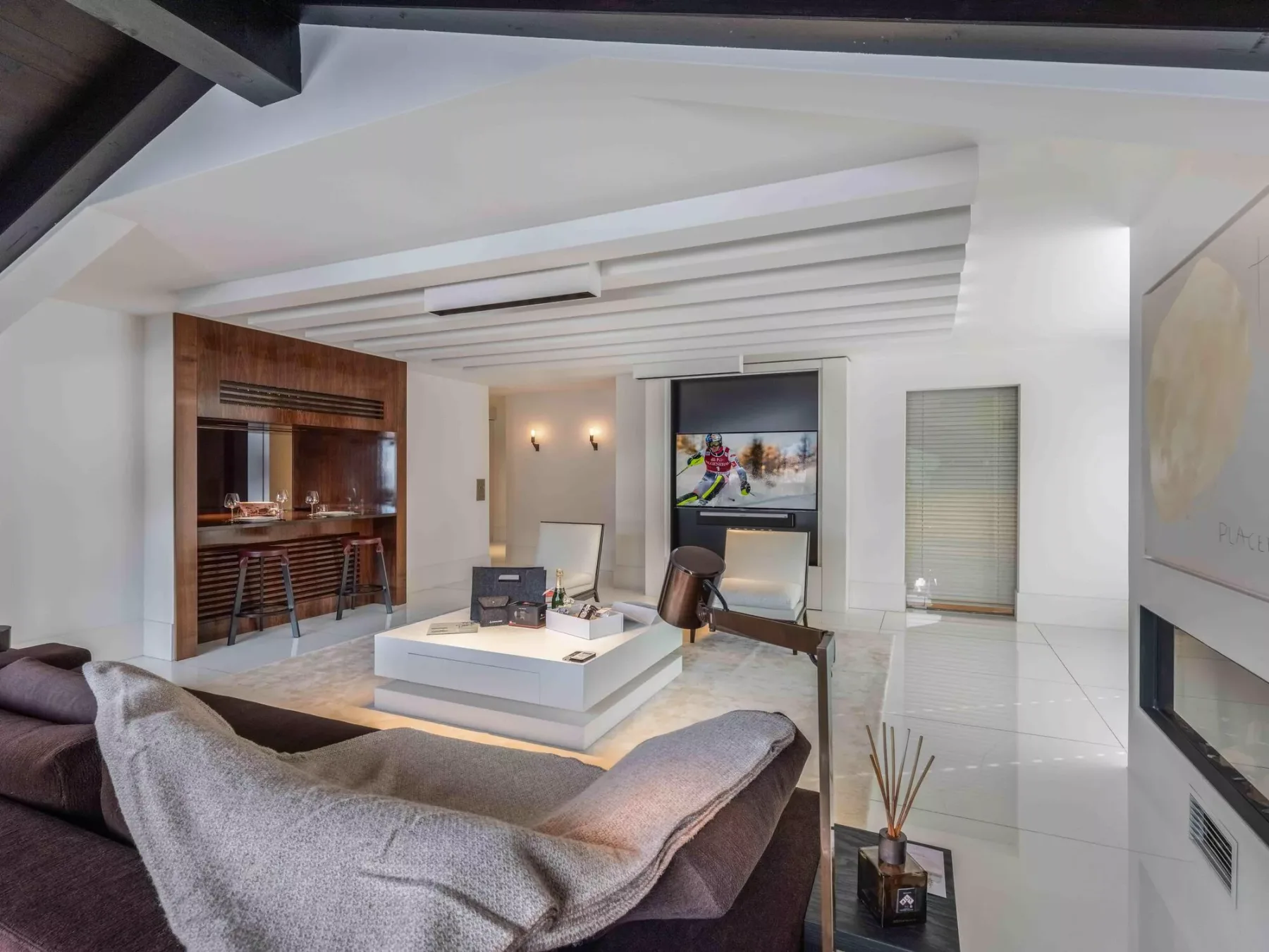 A modern living room with a low coffee table and a built-in bar.