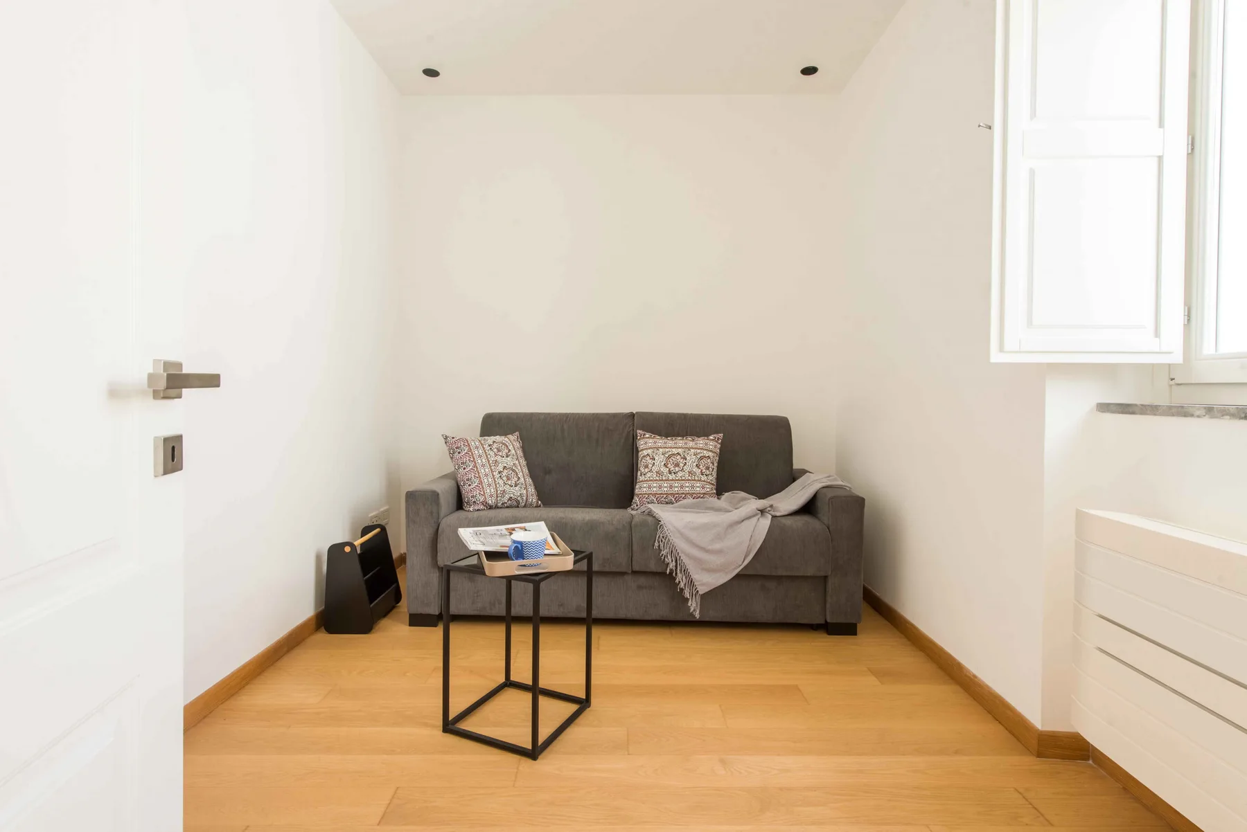 A small sitting area with a sofa, cushions, and a coffee table.