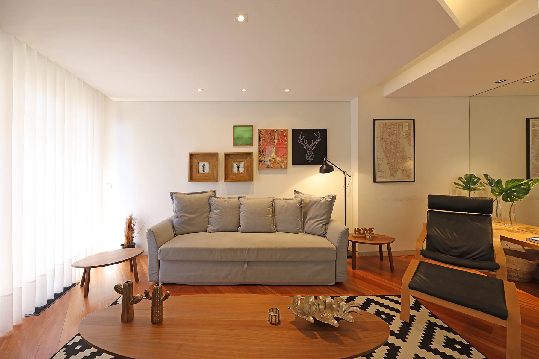 A living room with seating, a coffee table, and framed artwork.