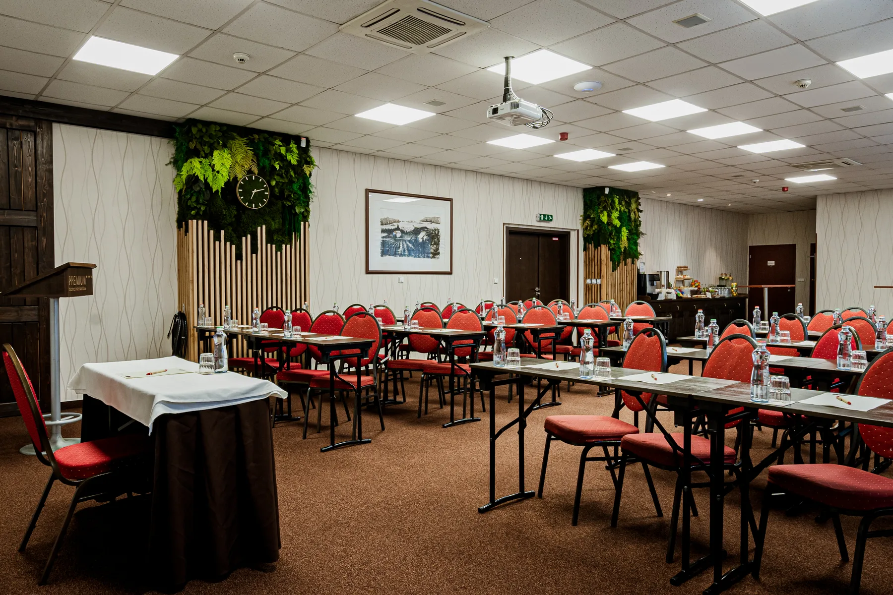 Conference room with projector, lectern and refreshment area.