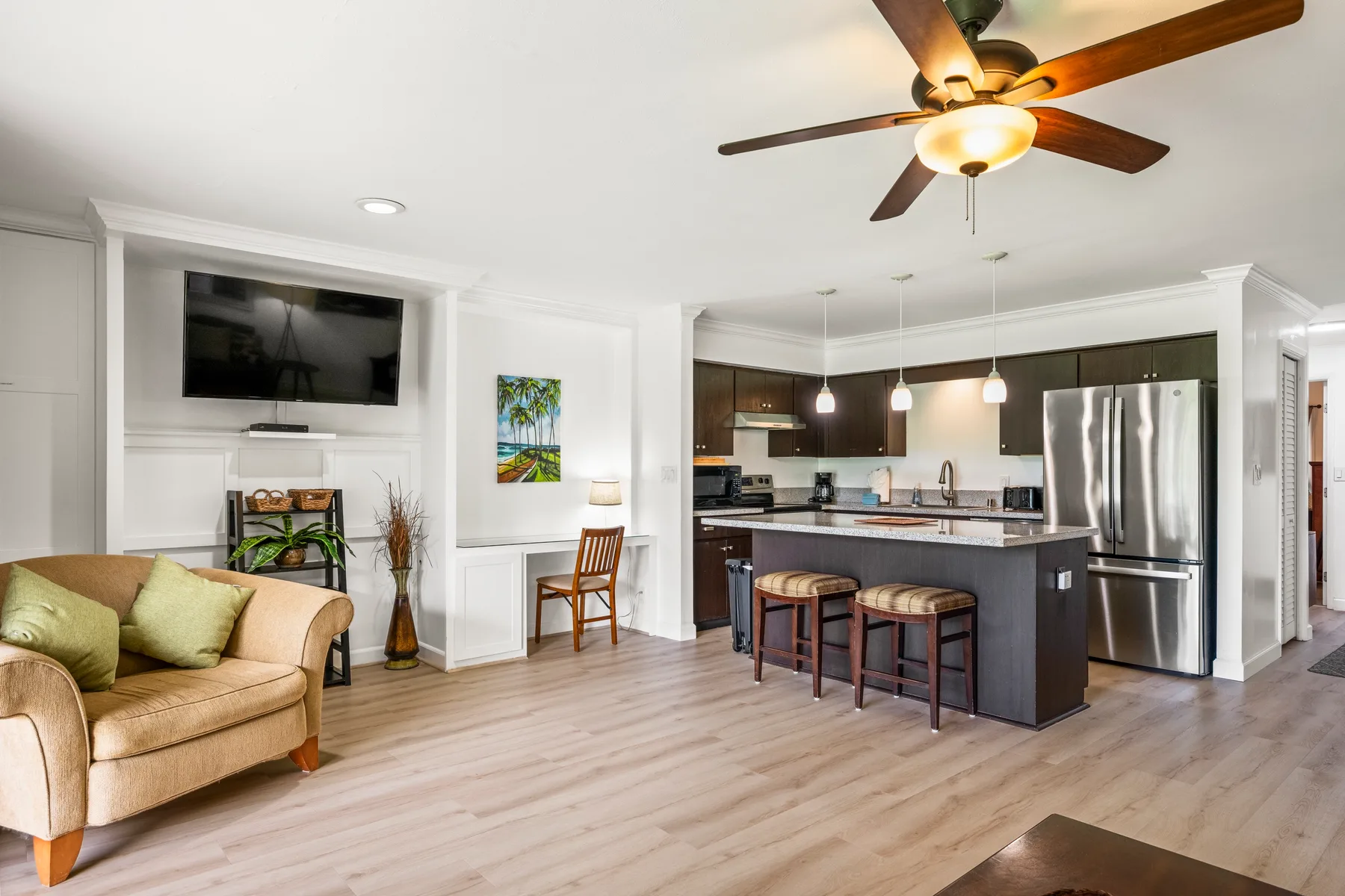 An open-plan living room and kitchen with a seating area and breakfast counter.