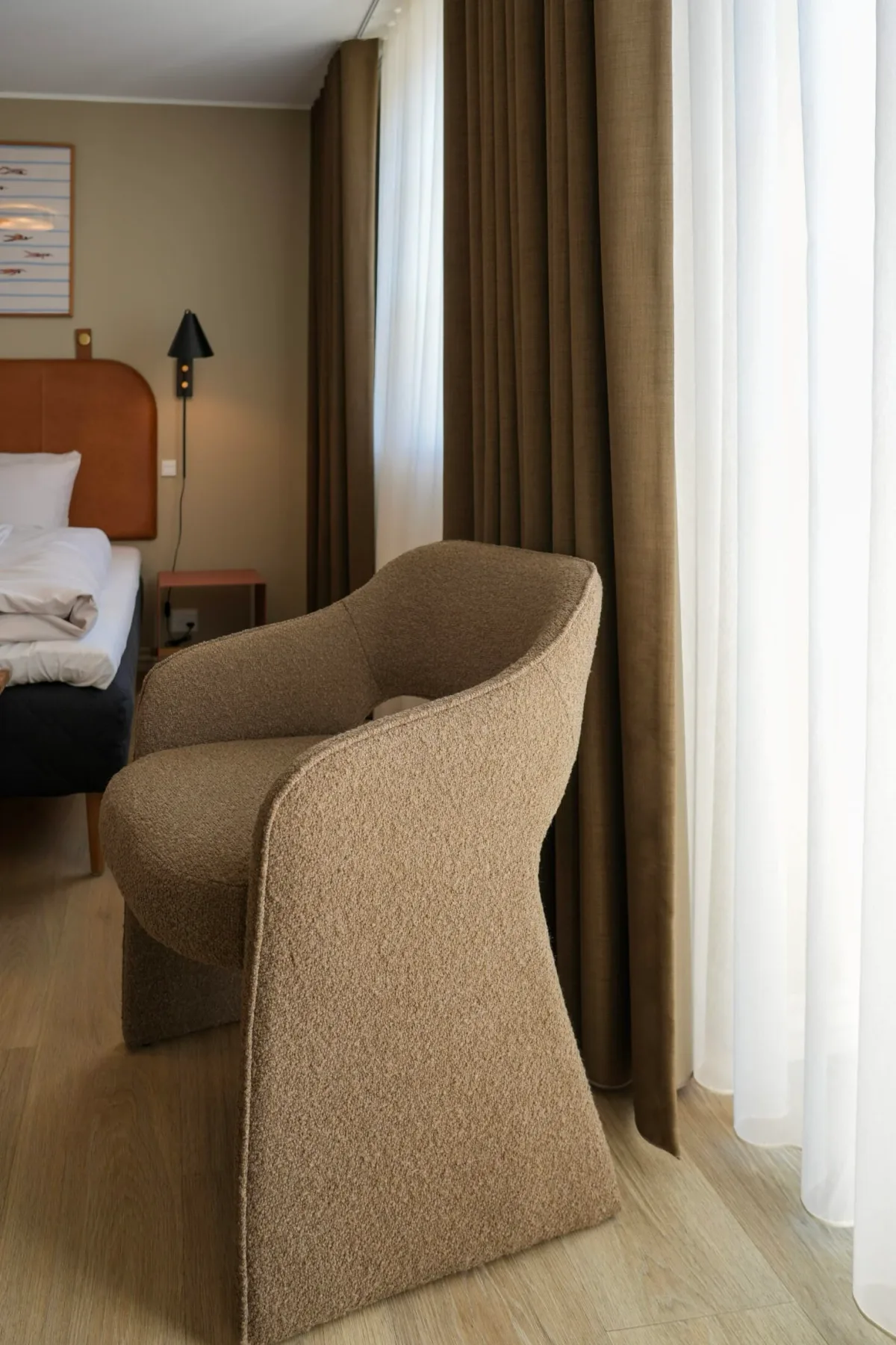 Hotel room with an armchair and curtains