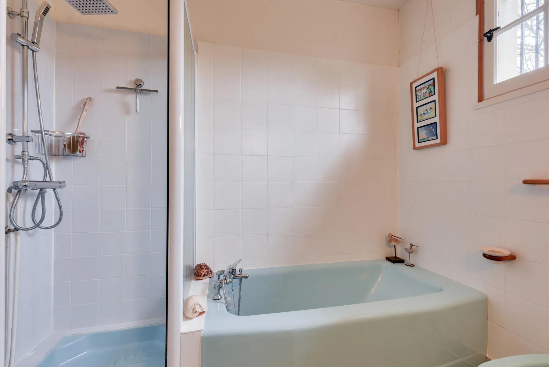 A bathroom with a bathtub and a separate shower area.