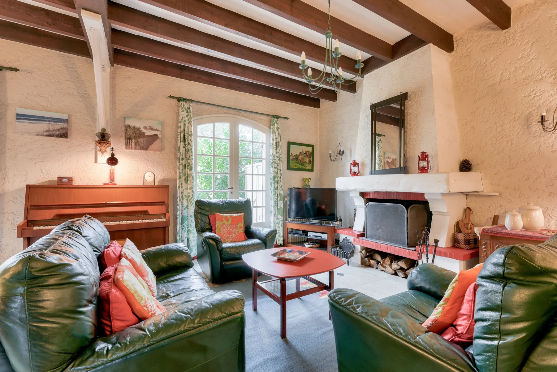 Living room with green seating, a coffee table, and a fireplace.