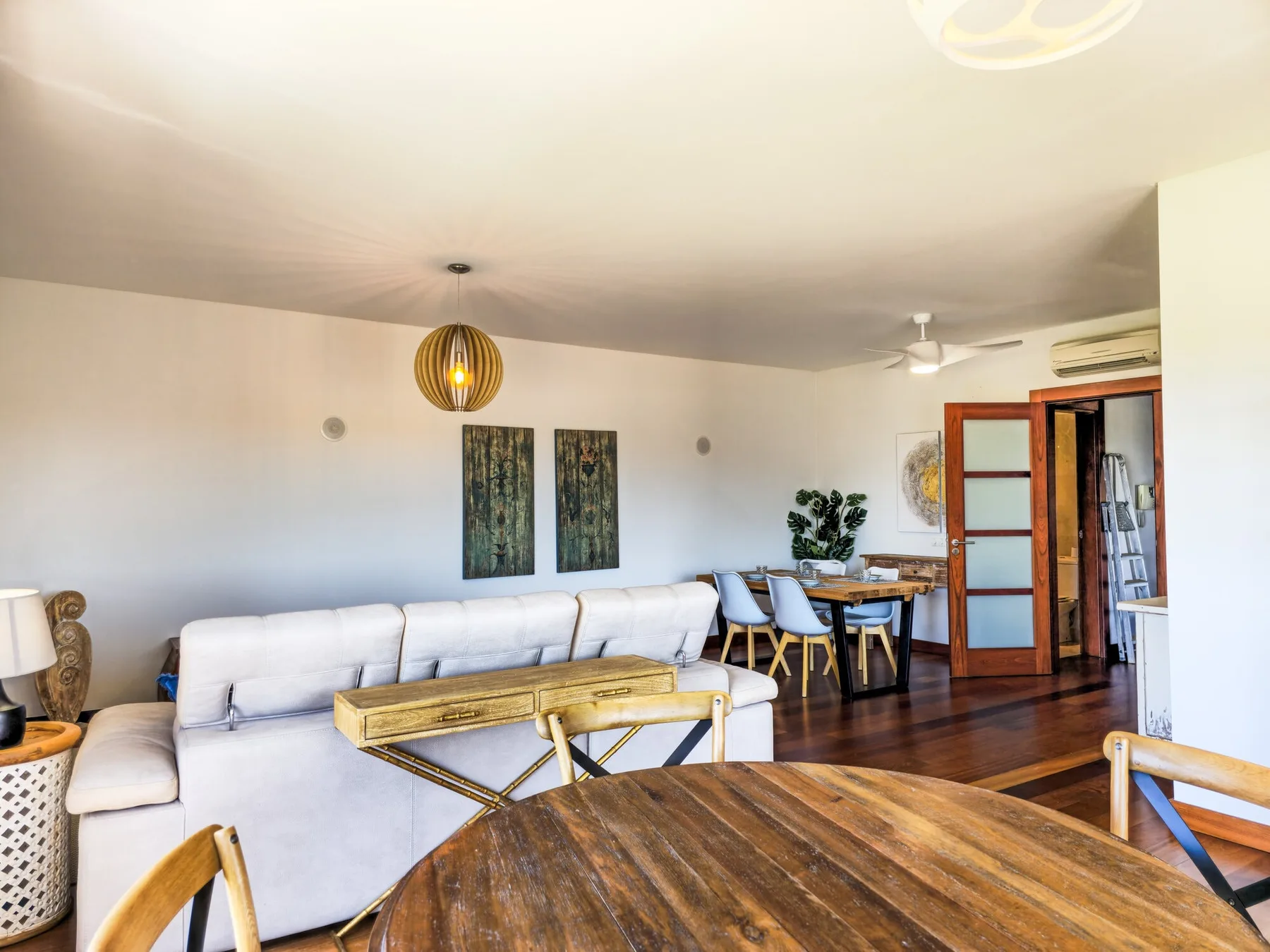 Living and dining area with a sofa, table, and chairs in an open room.