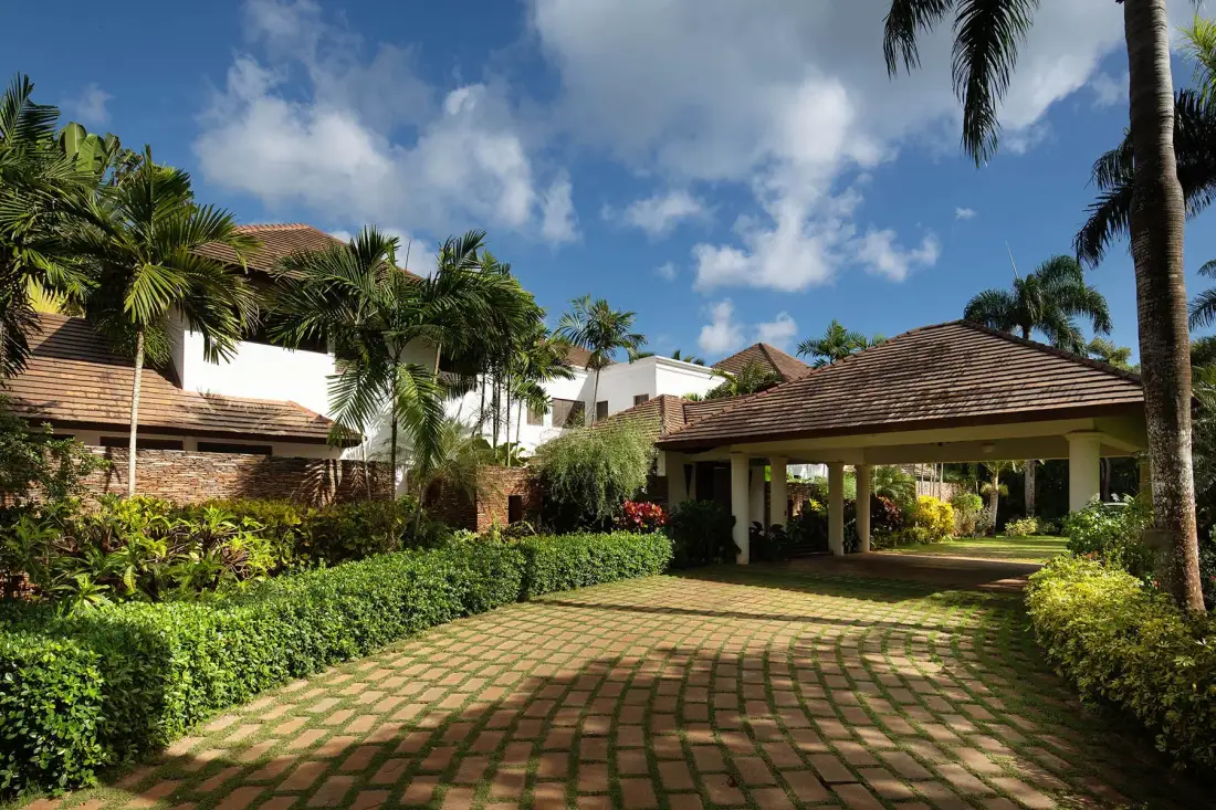 A landscaped courtyard with a paved path leading to a covered entrance.