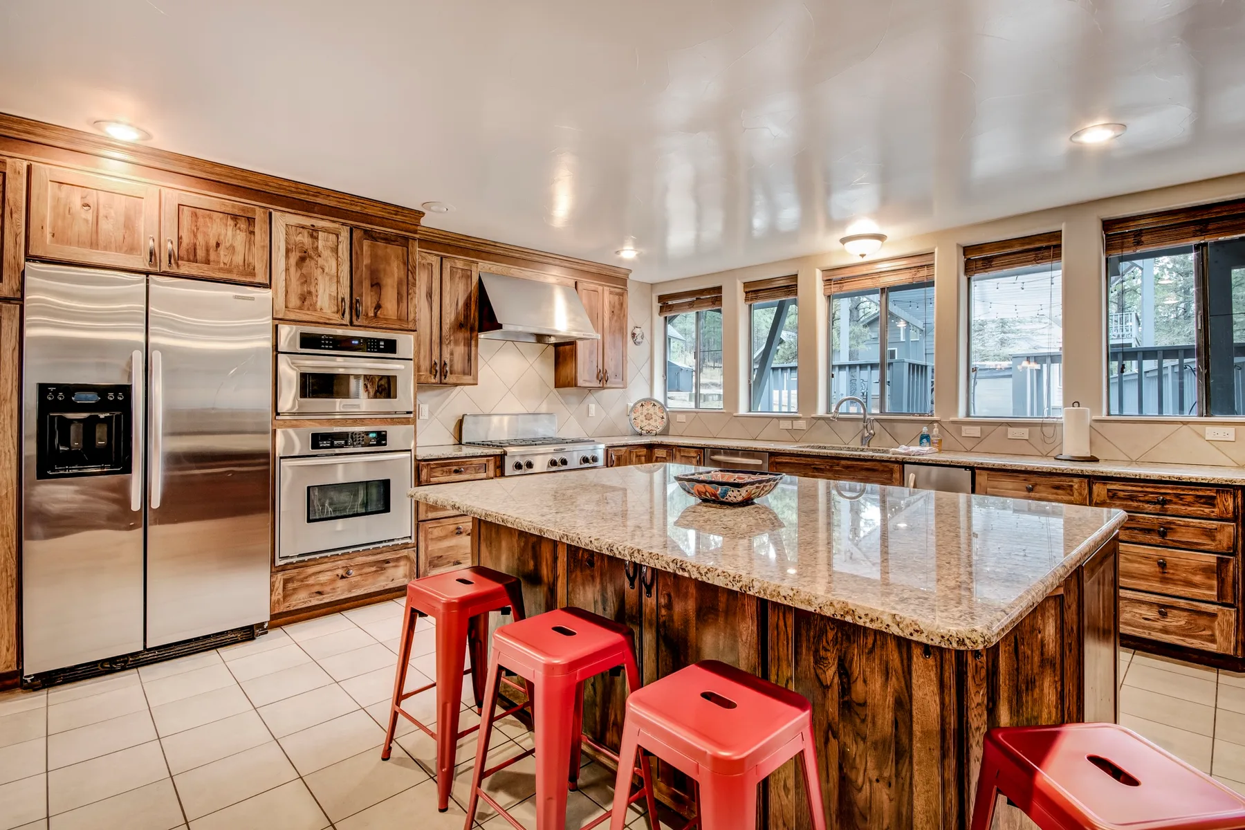 A spacious kitchen with wooden cabinetry and a large central island.