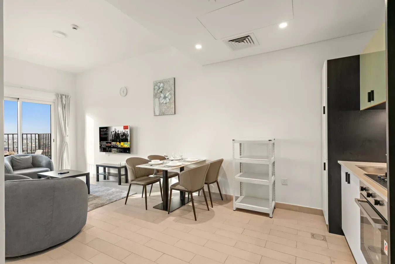 A bright open-plan living and dining area with seating and a dining table.