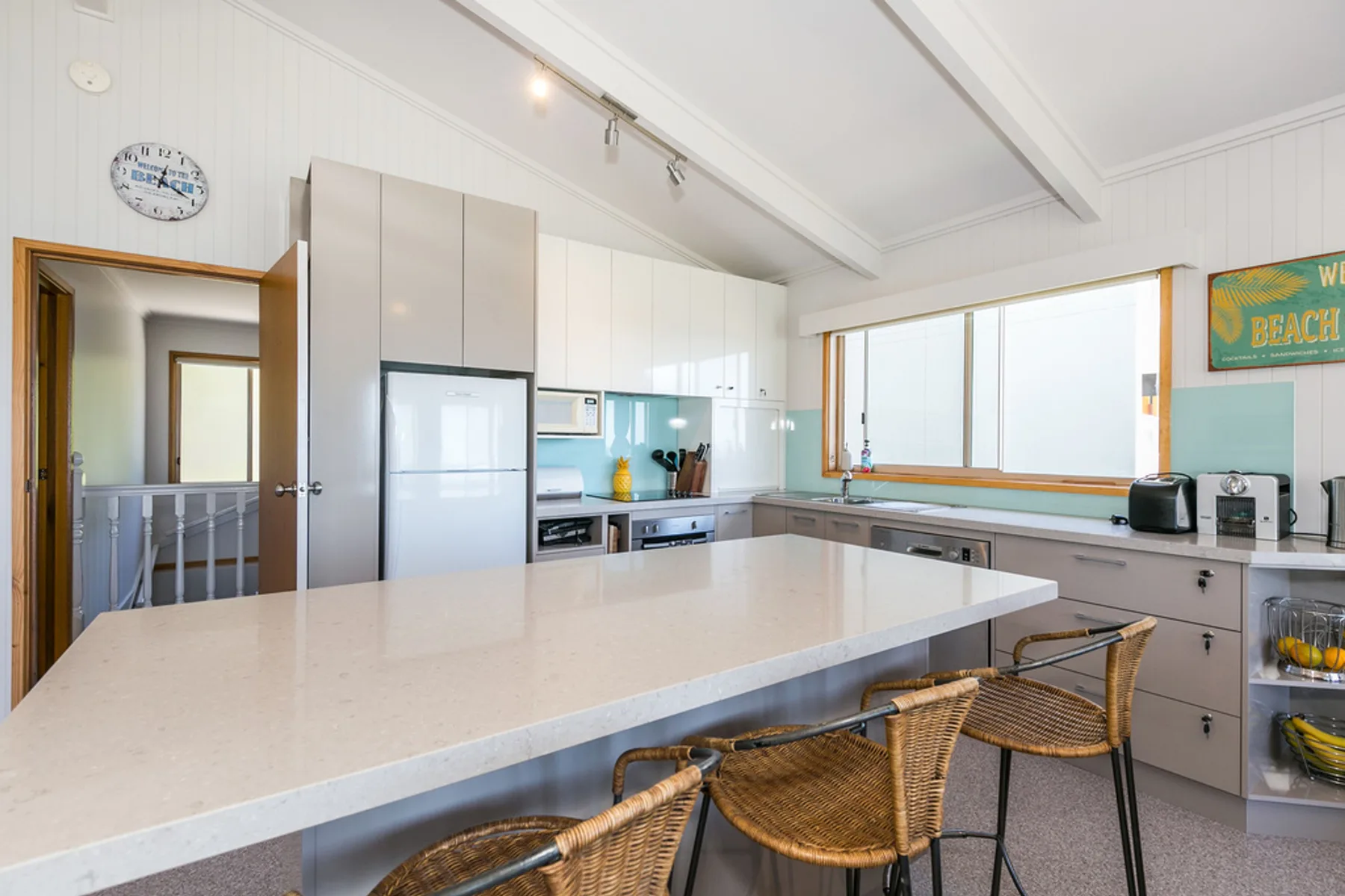 A bright kitchen with a large island and bar seating.