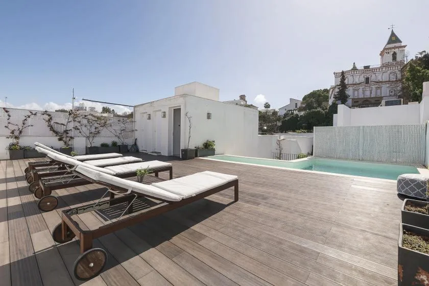 A rooftop terrace with lounge seating and a small swimming pool.