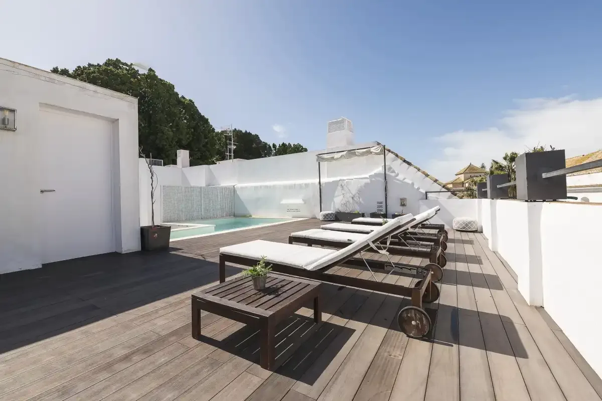 A rooftop terrace with lounge seating and a small pool.