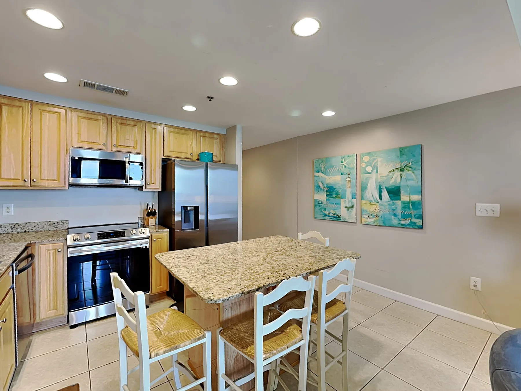 A kitchen and dining area with wooden cabinets and a large island.