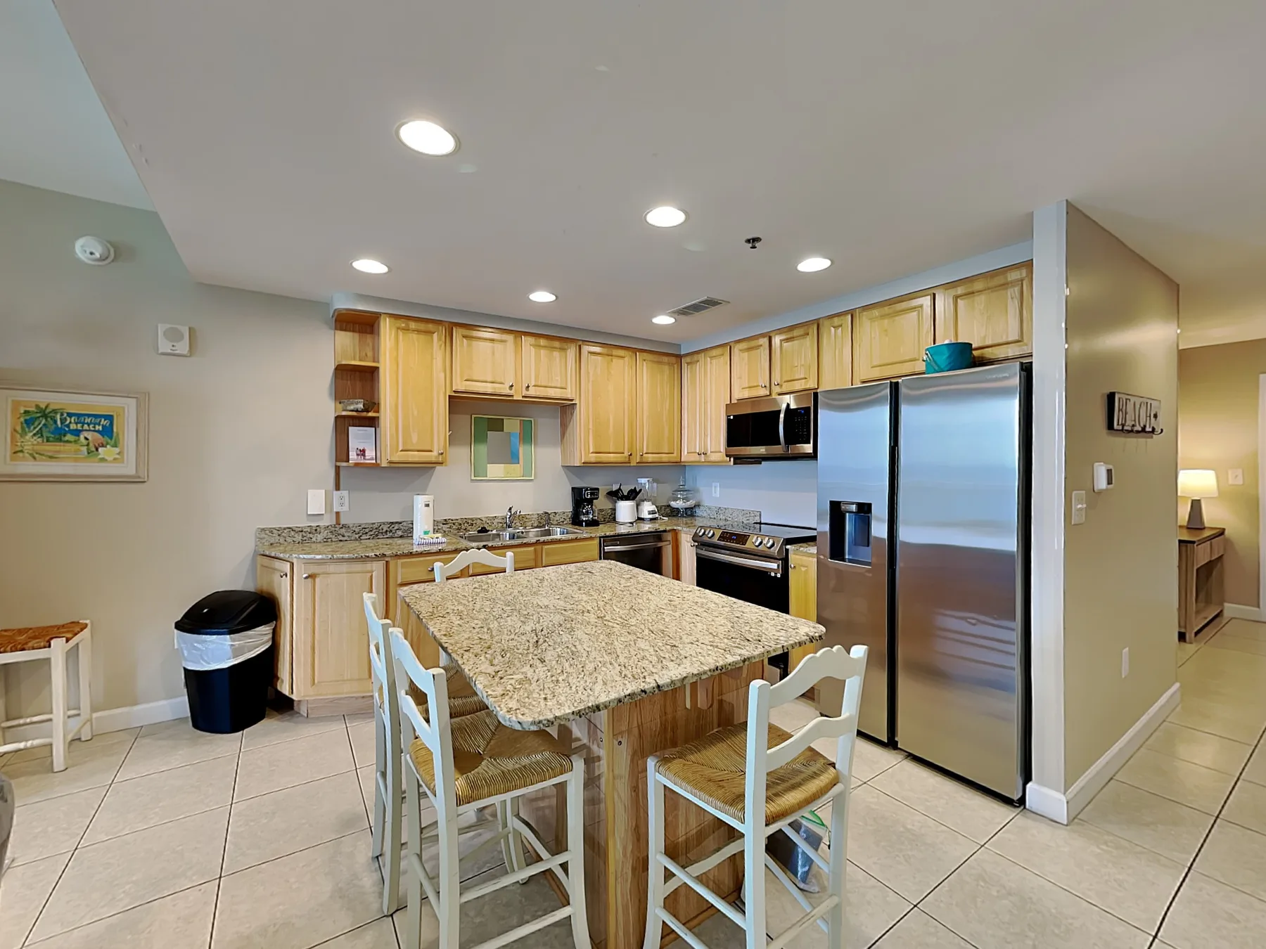 A kitchen with wooden cabinets, stainless steel appliances, and a central island.