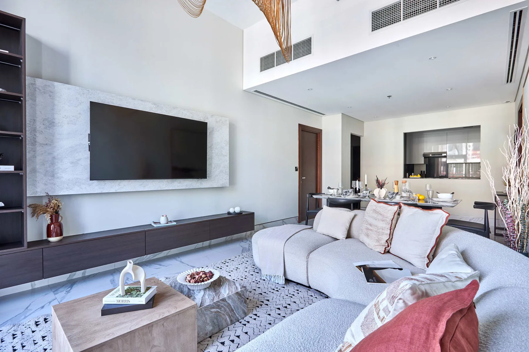 A modern living room with a large television above a low console.
