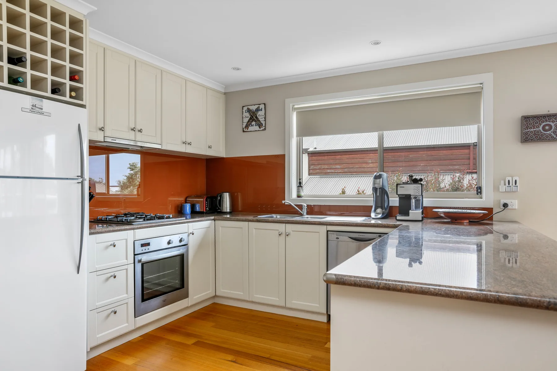 Kitchen with pale cabinets, a countertop, and a central island.