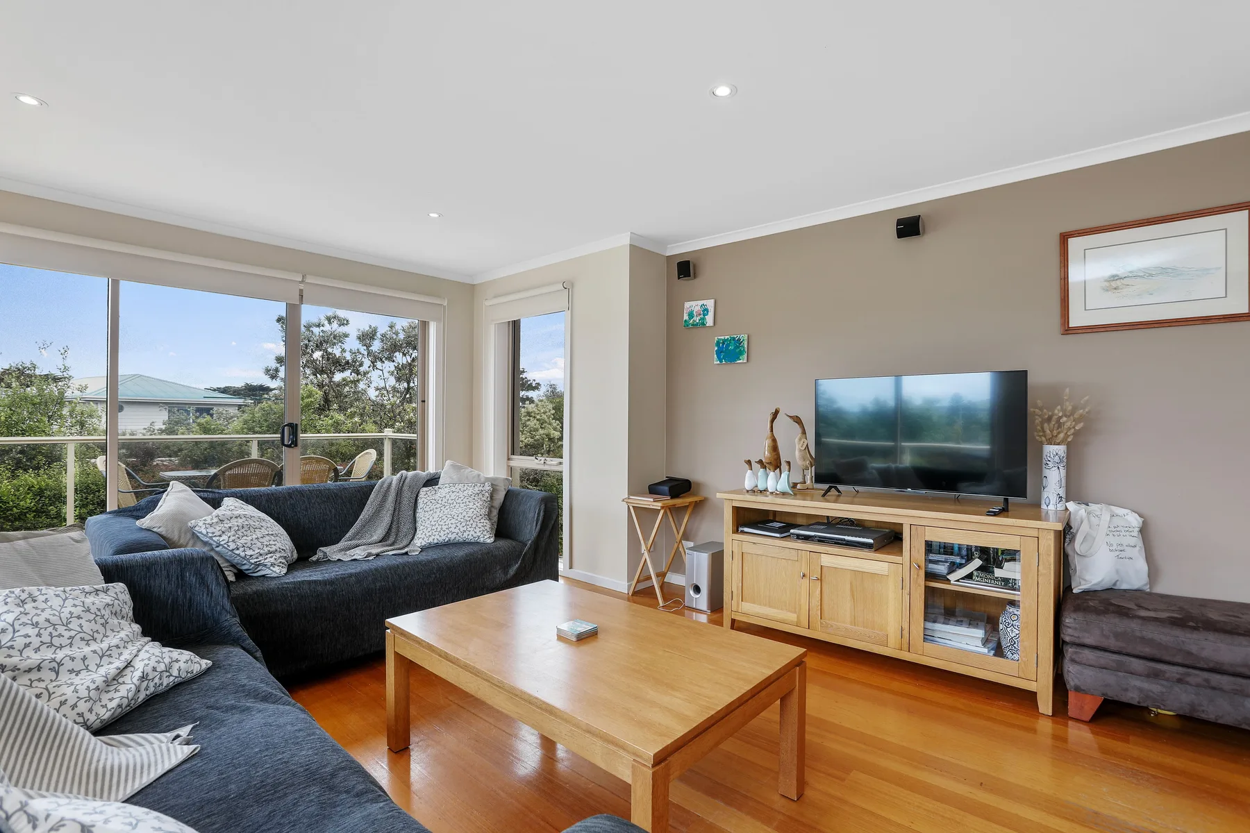 A living room with seating, a wooden coffee table, and a television.