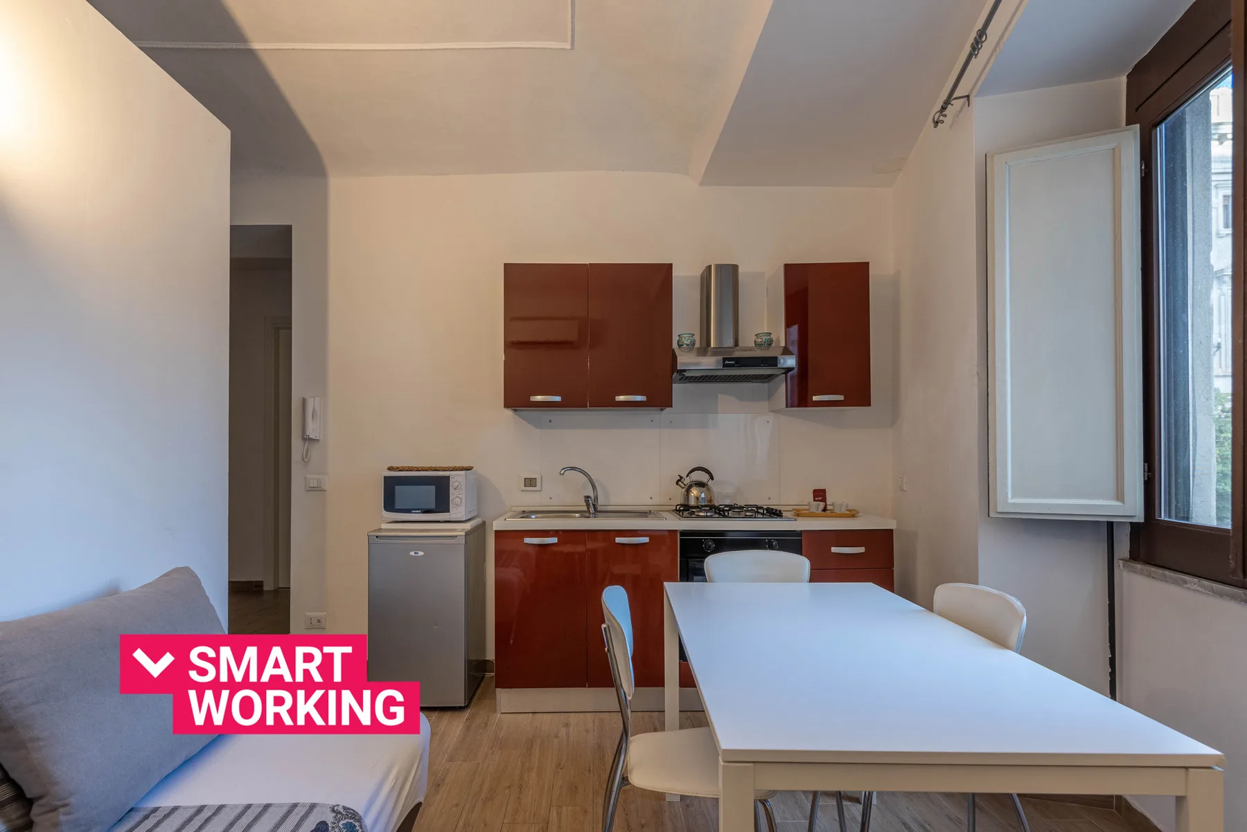 A compact kitchen and dining area with a table beside the window.