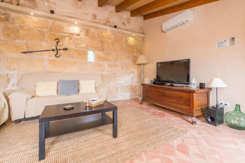 A living room with seating, a television, and a low coffee table.