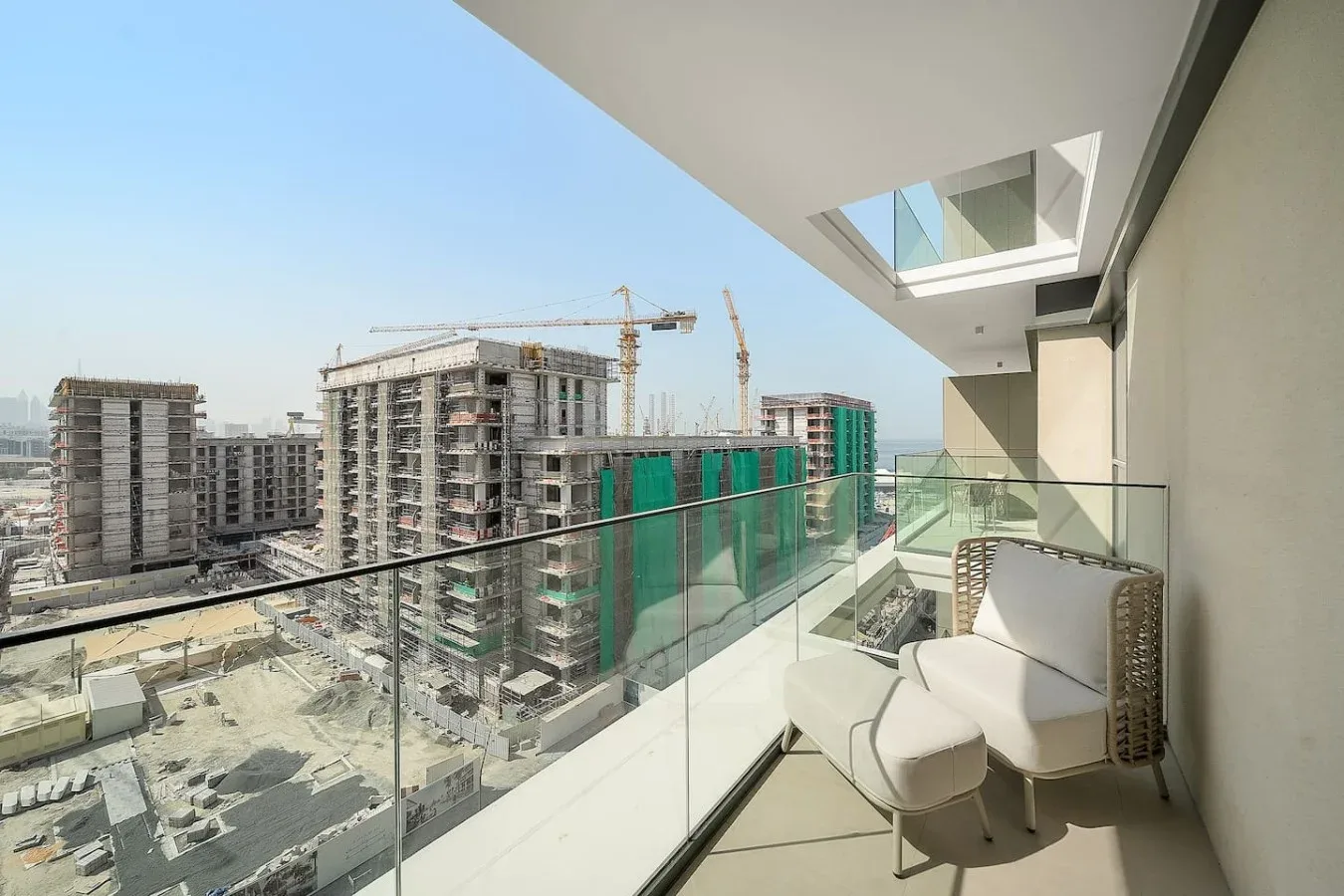 A balcony overlooks several high-rise buildings under construction.