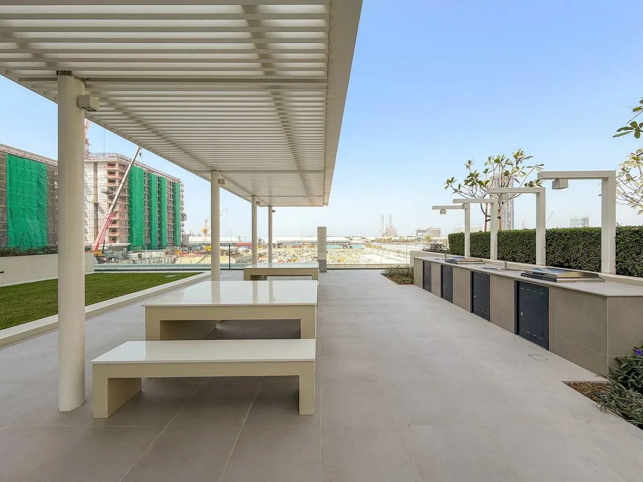 A covered outdoor terrace with built-in seating and a row of planters.