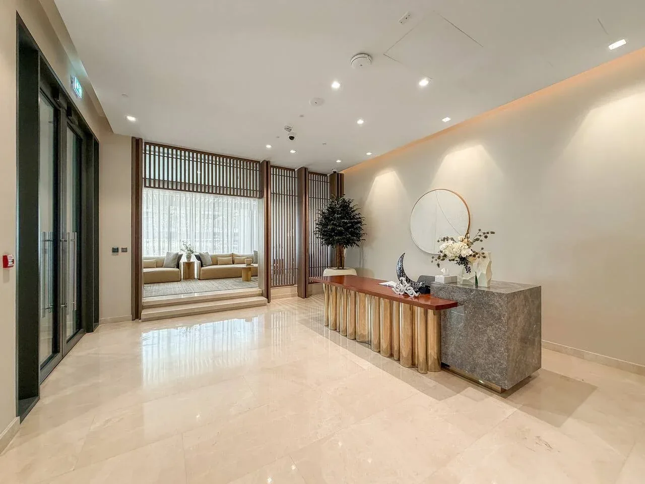 A spacious reception area with a long counter and seating visible beyond a partition.