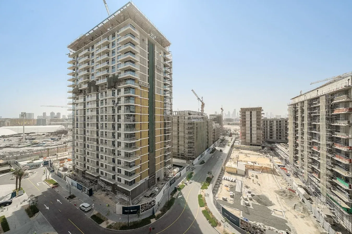 A city construction site with several high-rise buildings and a crane.