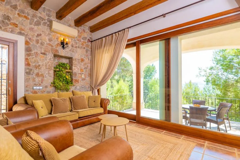 A living room with seating and large glass doors opening onto a patio.