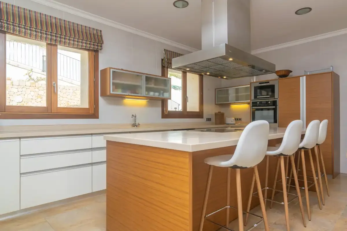 A modern kitchen with a central island and bar seating.