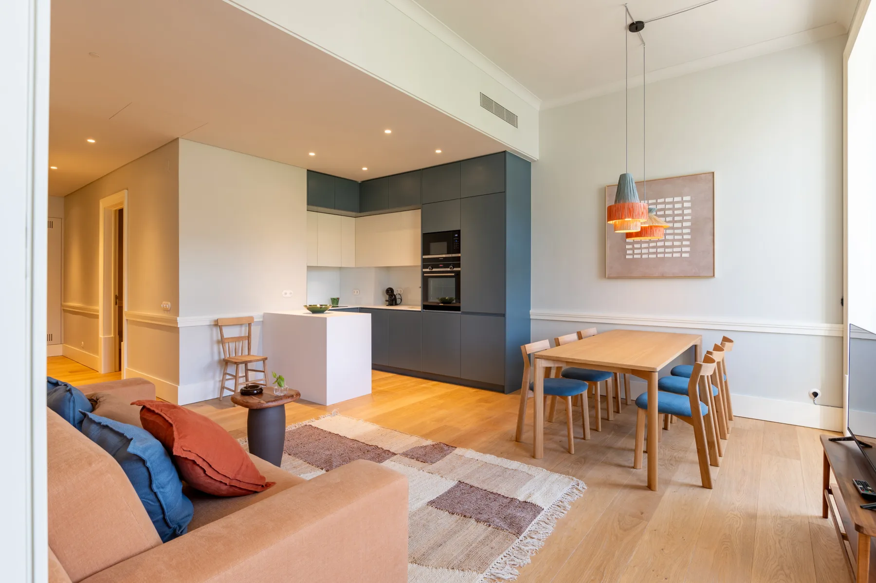 A bright open-plan living and dining area with a compact kitchen.