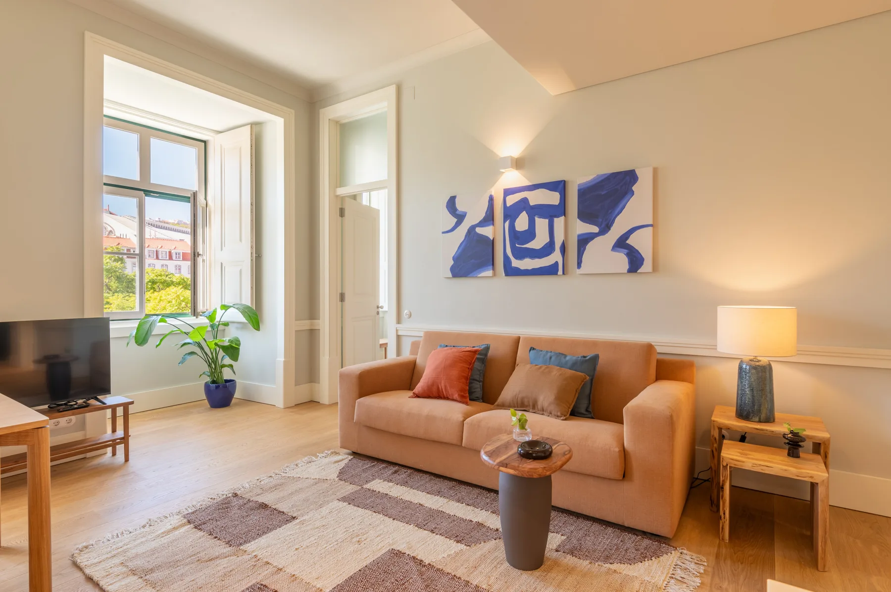 Living room with seating, a coffee table, and a large window.