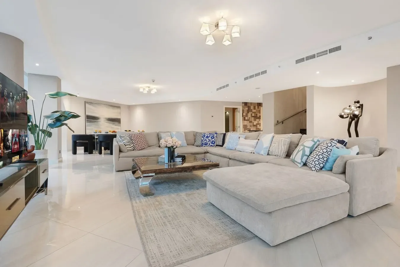 A bright living room with a sectional sofa and a low coffee table.
