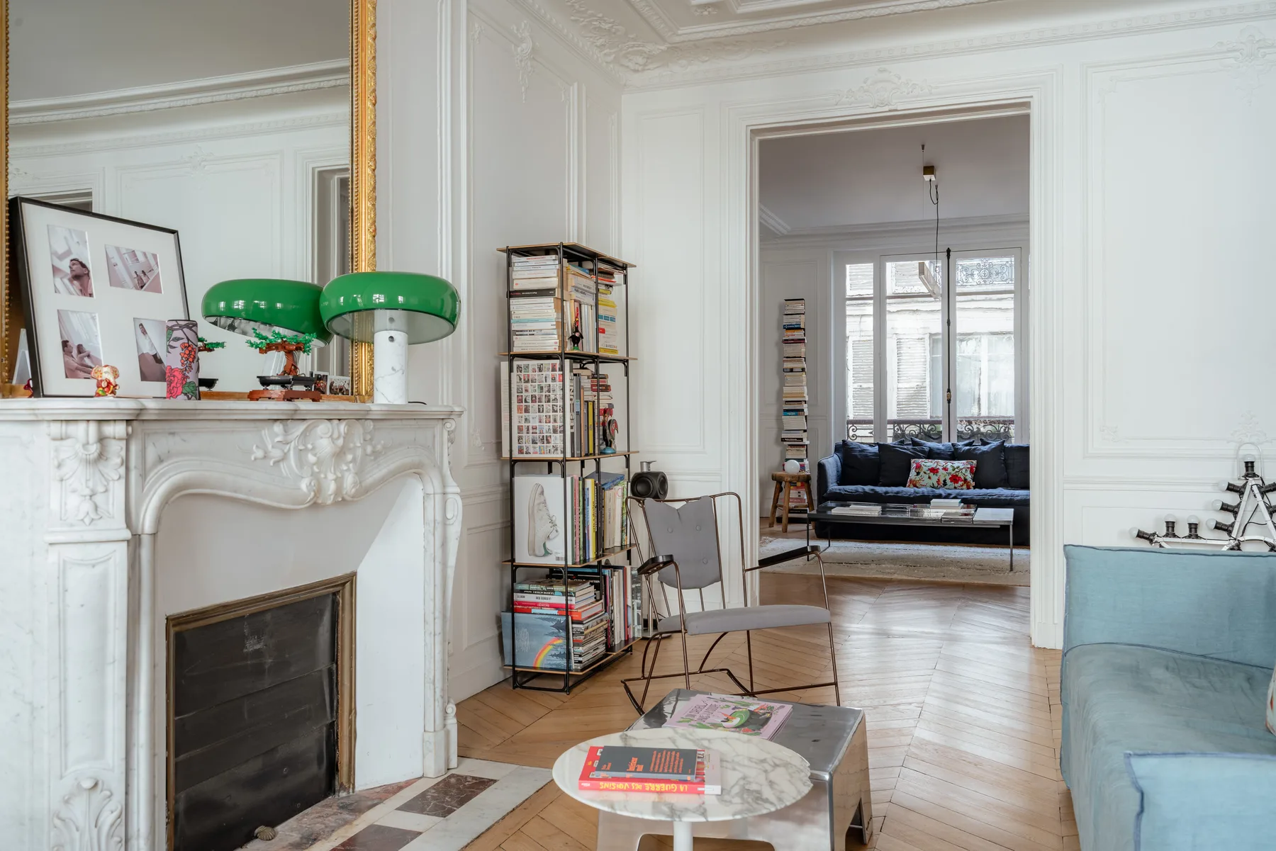 A bright living room with a fireplace, low table, and seating.
