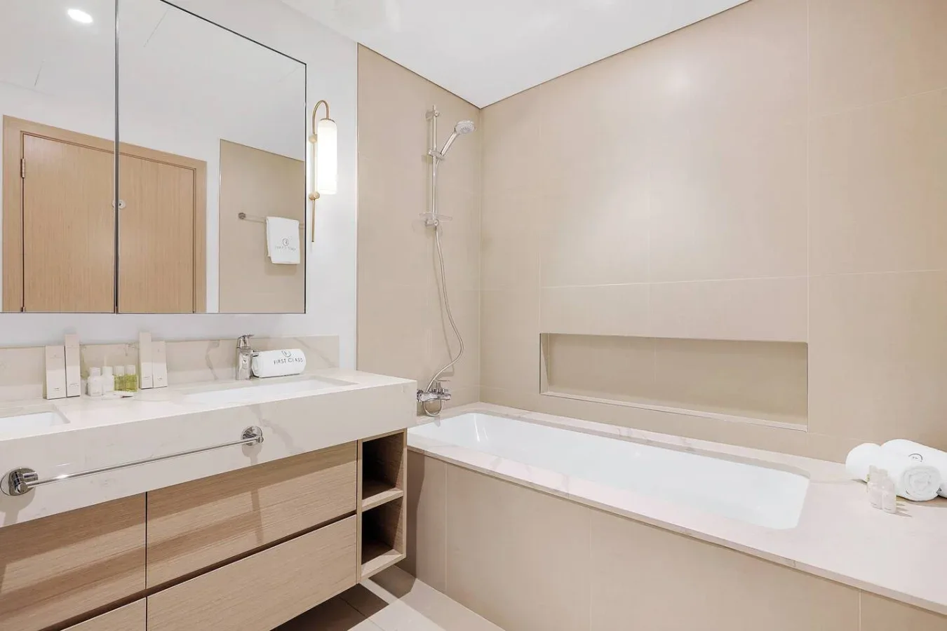 A bright bathroom with a bathtub, shower, and wide vanity.
