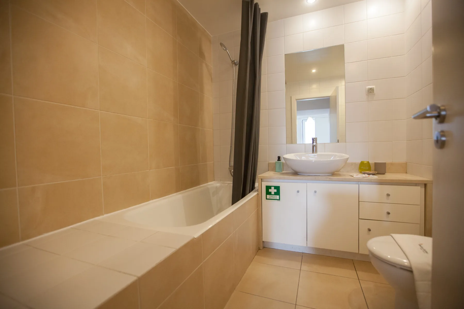 Un baño con azulejos, bañera, lavabo e inodoro.
