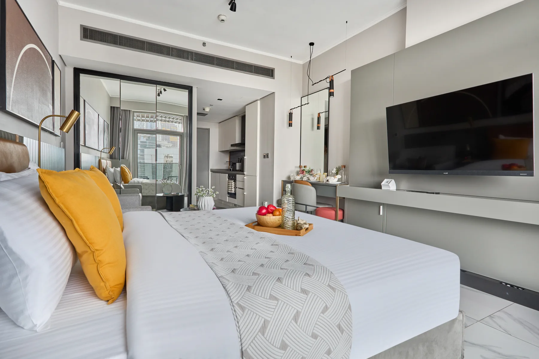 A modern bedroom with a bed and a wall-mounted television.