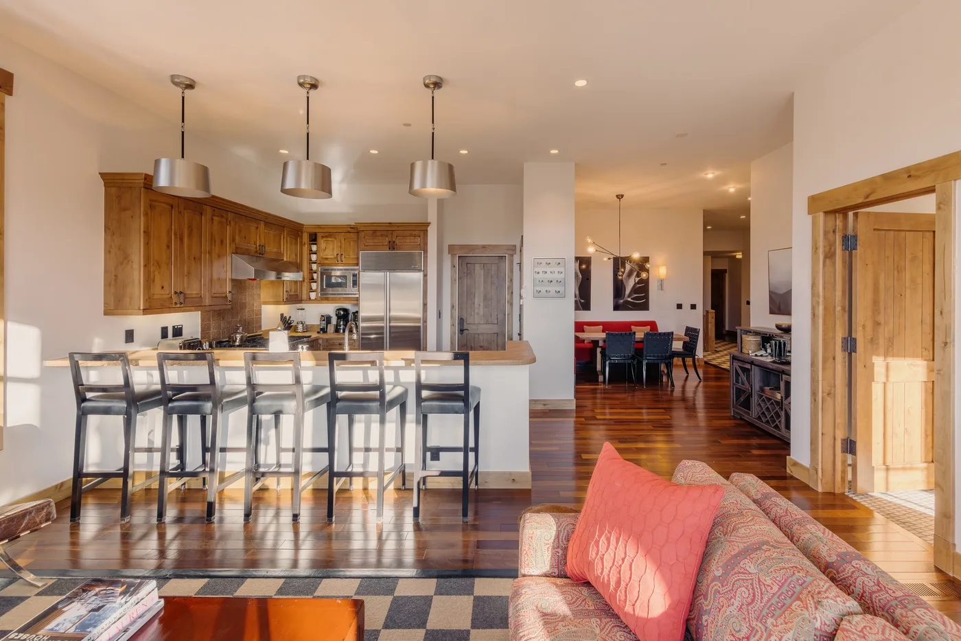An open-plan kitchen and living area with a dining table beyond the island.