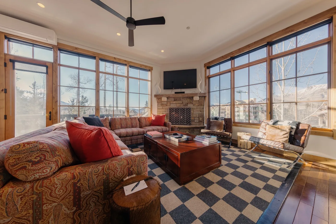 A living room with seating around a coffee table and a fireplace.