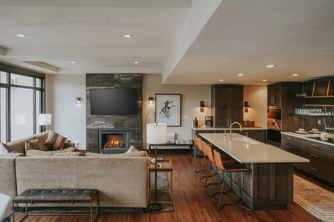 Open-plan living room and kitchen with a central island and seating.