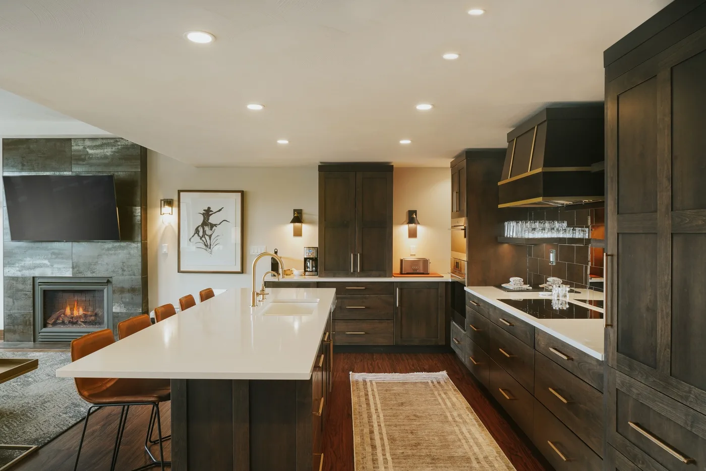 An open kitchen and dining area with dark cabinetry and a long island.