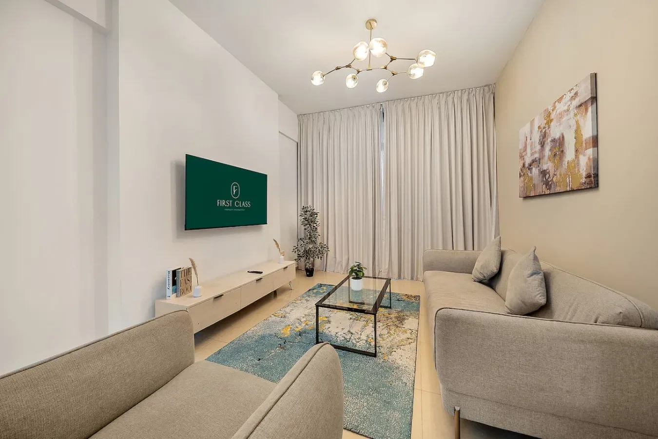 Living room with seating, a wall-mounted television, and a coffee table.