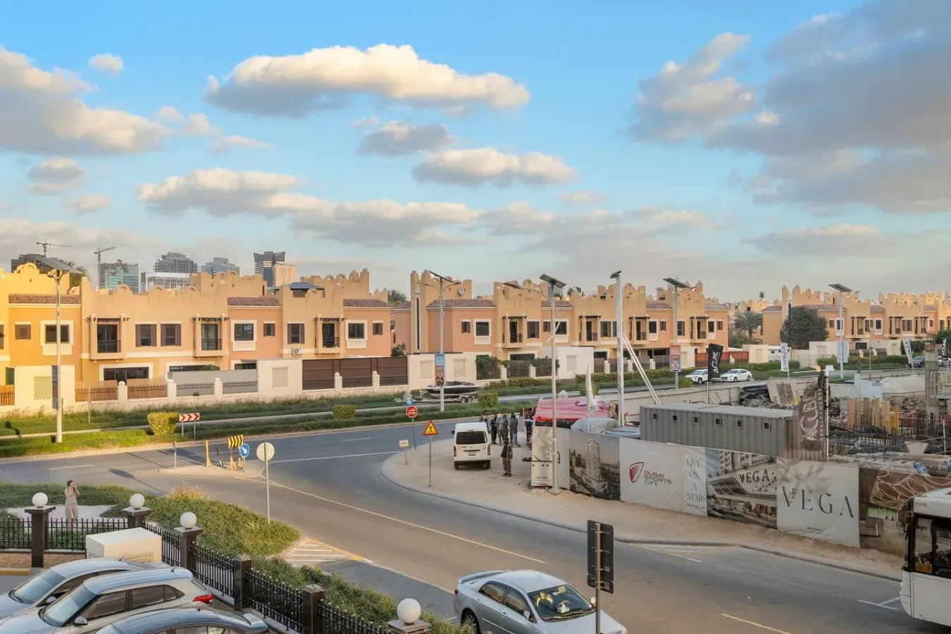 A residential neighborhood with rows of low-rise homes along a curved road.